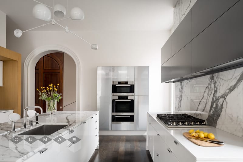 White marble kitchen counter top with a stove in a modern home