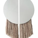 The Apollo mirror, named for the Greek God of the Sun, comprises two half-circle mirrors joined by negative space and partnered with hand-spun, hand-painted silk fiber.