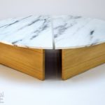The two halves of the Half Moon coffee table are placed together to create dynamic spacing in the center of the table.