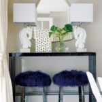 Blue console with polished marble lamps.