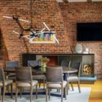 Contemporary dining room with exposed brick walls