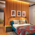 Contemporary master bedroom with wood floating wall