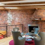 Contemporary seating area with fireplace and exposed brick wall
