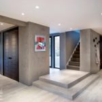 Contemporary hallway with neolith walls and wood-look ceramic floors