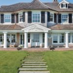Exterior shingle style home with weathervane