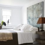 Guest room with a painting as the headboard