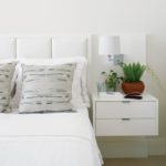 White bed with built-in nightstand