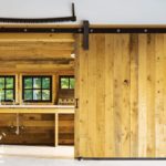 Vermont shingle style home potting shed with barn doors