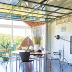 The interior and the screened porch become one when a glass garage door is raised.