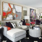 The living room of designer Antonio Vergara features shades of black, white and gray with pops of orange accessories.