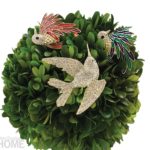 A wreath adorned with three crystal and enamel birds