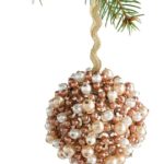 Ball Christmas ornament studded with white and champagne-colored pearls