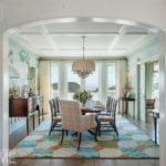Dining room with eight-person dark wood table and a colorful, geometric rug
