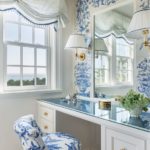 a white vanity with a blue and white upholstered chair