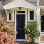 blue front door of shingle-style home