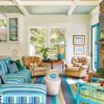living area with blue and green striped sofa and rug