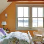bedroom with water views and orange walls