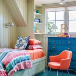 kid's bedroom with blue floors, blue bureau and orange chair