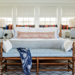 Master bedroom with white bedding and a red and white pillow