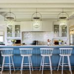 Large coastal kitchen with a bright blue island