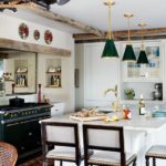 Traditional white kitchen with green pendant lights