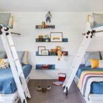 bunk room with white walls and blue bedding