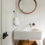 Contemporary white powder room with nickel-gap paneling