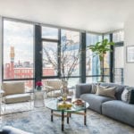 Masculine condo in Boston with a gray sofa and large windows