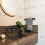 Powder room with Phillip Jeffries studded wall covering
