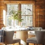Dining area with round table and rustic wood walls