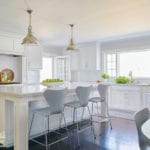 White kitchen with contemporary gray bar stools