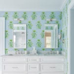 White bathroom vanity with blue and green Katie Ridder wallpaper