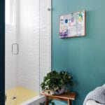 Turquoise bathroom with white tiled shower