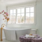 White freestanding tub under a window