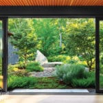 Large glass window over looking contemporary garden.