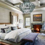 Main bedroom with grasscloth walls and dramatic. chandelier.
