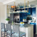 Contemporary kitchen with bold blue cabinetry and floral wallpaper.