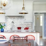 White kitchen with white and brass light fixtures.