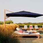 Double chaise lounge with large navy blue umbrella