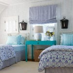 Two twin beds and a turquoise night stand.