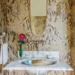 Powder room with botanical wallpaper.