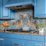 Bright blue kitchen with leopard tiled back splash.