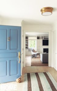 Neutral entryway with a blue door