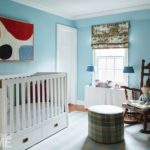 Nursery with light blue walls and abstract art