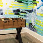 Foosball table with bright mural