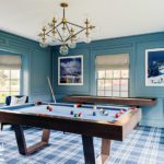 Billiard room with blue walls and plaid rug
