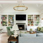 Family room with book cases and large contemporary brass chandelier
