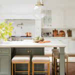 White kitchen with sage green island