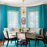Dining room with teal carpets and curtains