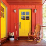 House entry with red siding and yellow door